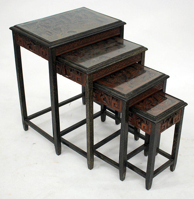 Appraisal: A NEST OF FOUR ORIENTAL CARVED WOOD OCCASIONAL TABLES with