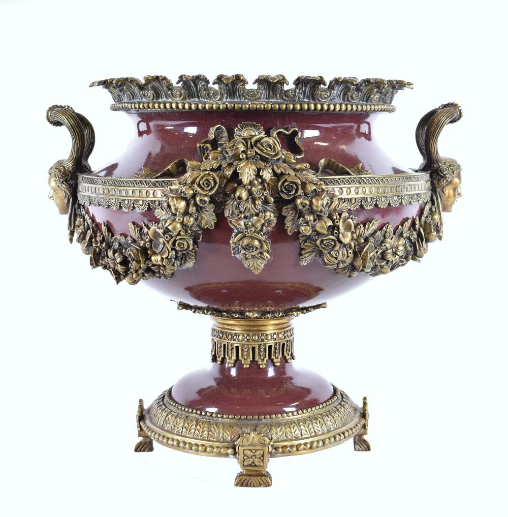 Appraisal: LOUIS XVI STYLE BRONZE-MOUNTED PORCELAIN CENTERPIECEModern The burgundy bowl-shaped urn