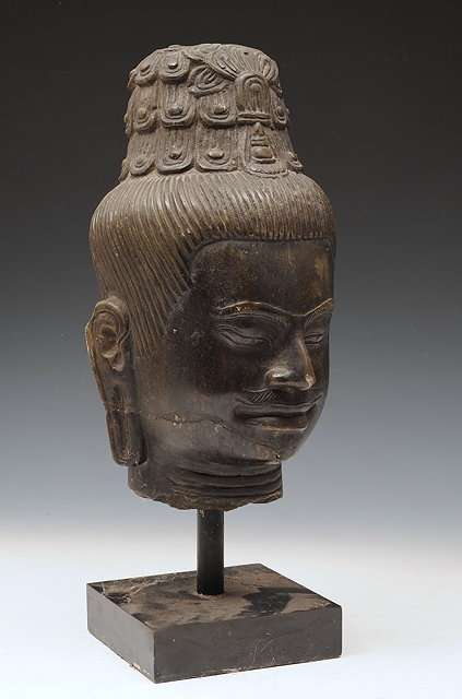 Appraisal: A THAI CARVED STONE HEAD of a buddha on a