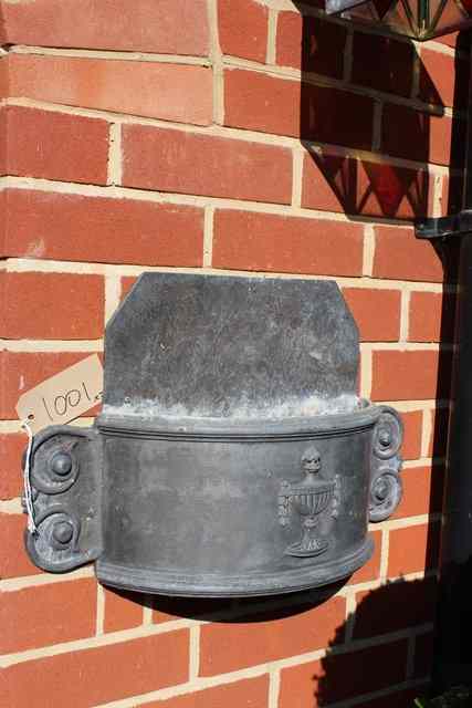 Appraisal: THREE WALL HANGING 'D' SHAPED LEAD PLANTERS with classical urn