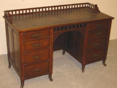 Appraisal: A VICTORIAN WALNUT PANELLED DESK the leather lined top with