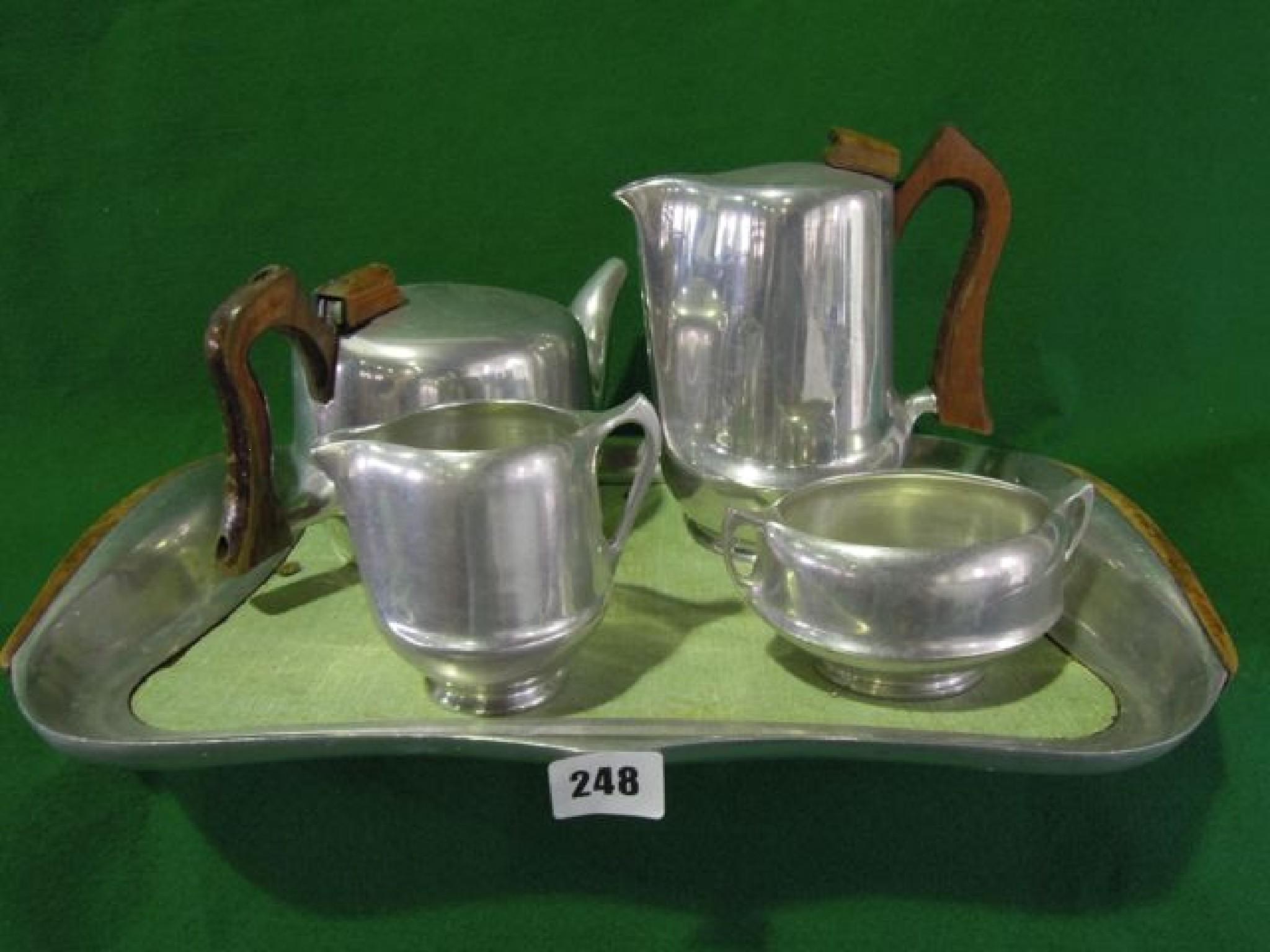 Appraisal: A piquot ware tea set comprising teapot milk jug sugar