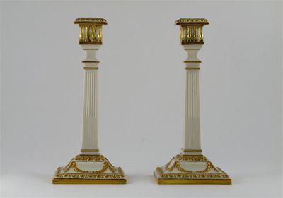 Appraisal: A pair of tall square-section Royal Worcester candlesticks each neck