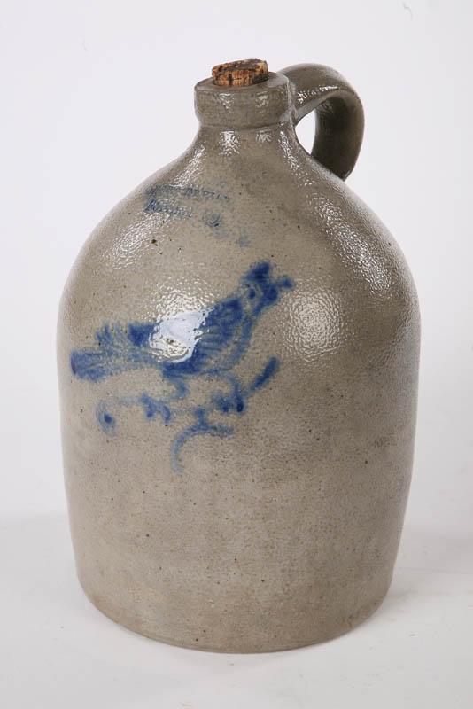 Appraisal: STONEWARE JUG Ovoid handled jug with cobalt bird decoration Impressed