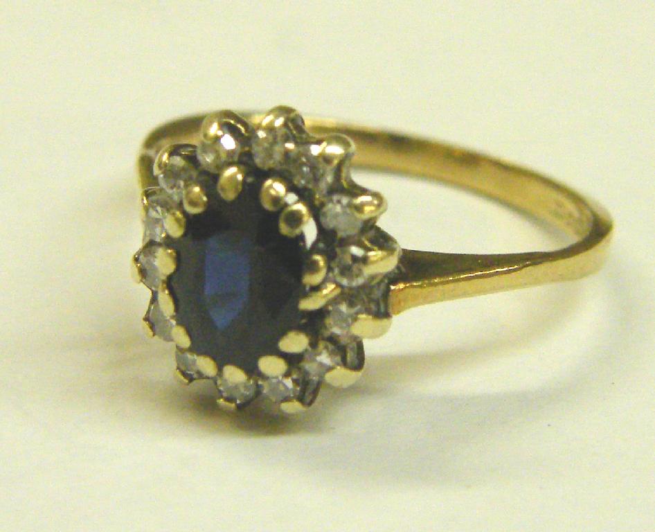 Appraisal: ct oval sapphire and diamond cluster ring