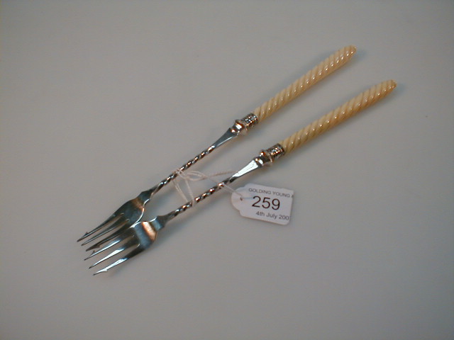 Appraisal: A pair of Victorian pickle forks with twist ivory handles