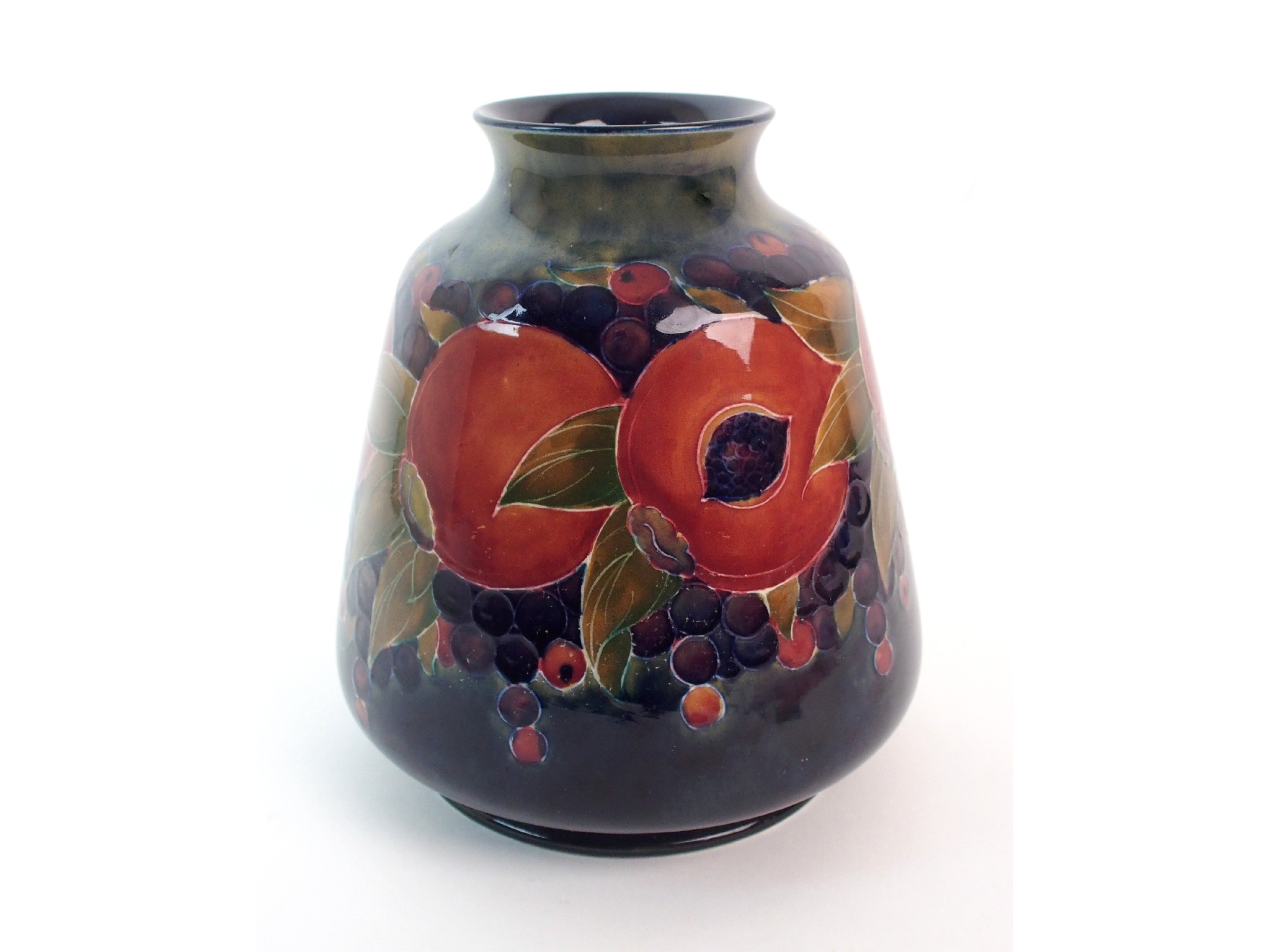 Appraisal: A Moorcroft Pottery Pomegranate vasecirca tapering ovoid-form vase with everted