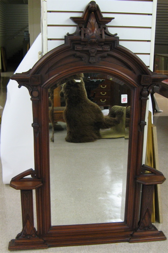 Appraisal: AN AMERICAN VICTORIAN BLACK WALNUT MIRROR The incised and carved