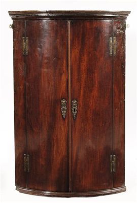 Appraisal: A George III mahogany bowfront hanging corner cupboard with a