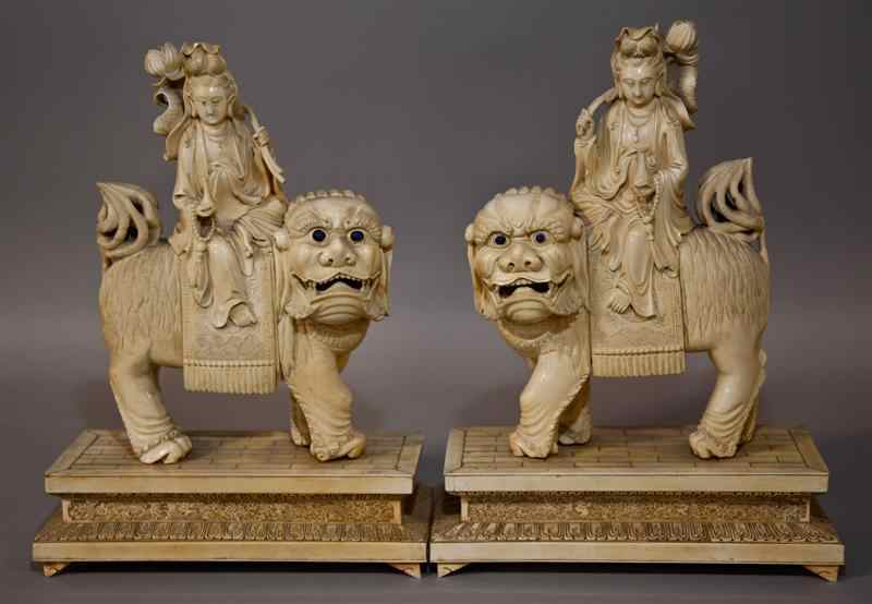 Appraisal: PAIR OF CHINESE IVORY VENEERED GUANYIN ON BUDDHISTIC LIONS the