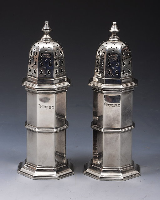 Appraisal: A PAIR OF SILVER CASTORS octagonal lighthouse shaped with pierced