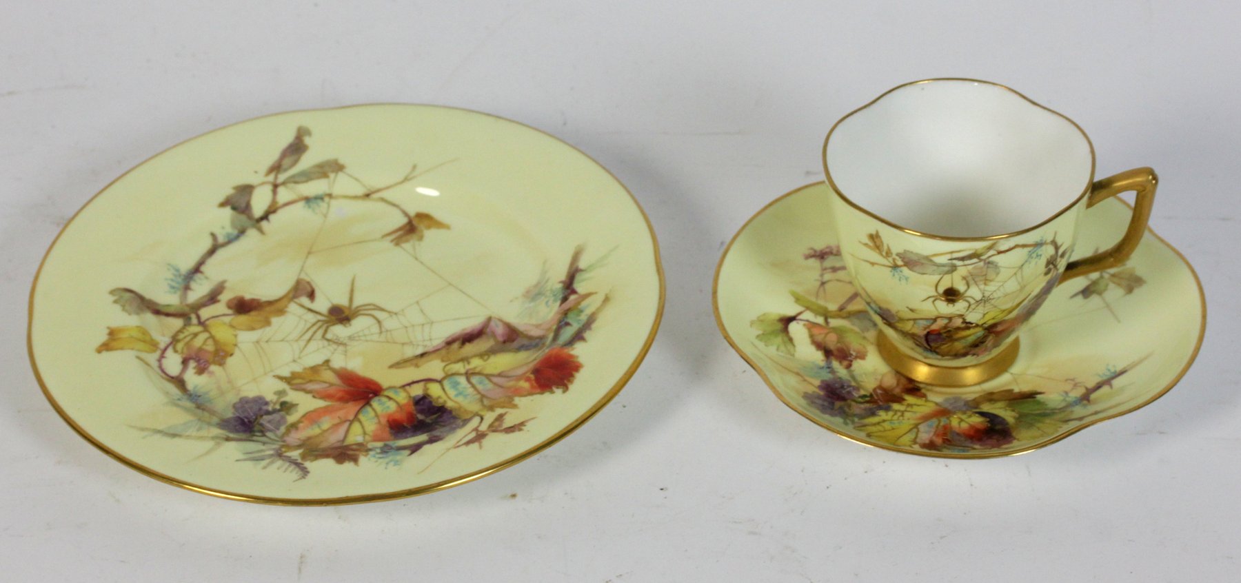 Appraisal: A Royal Worcester blush ivory trio painted a spider weaving