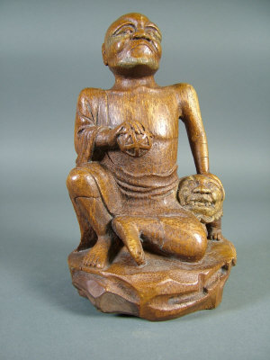 Appraisal: A Chinese carved bamboo figure of a seated man in