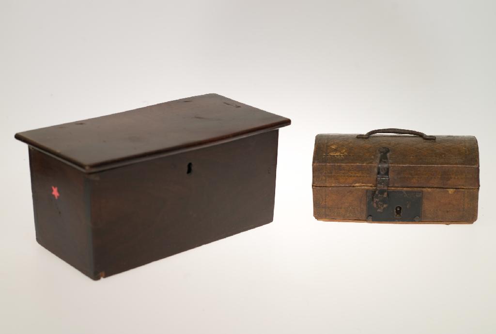 Appraisal: th CENTURY STAMPED LEATHER DOME-TOPPED CASKET with simple iron loop