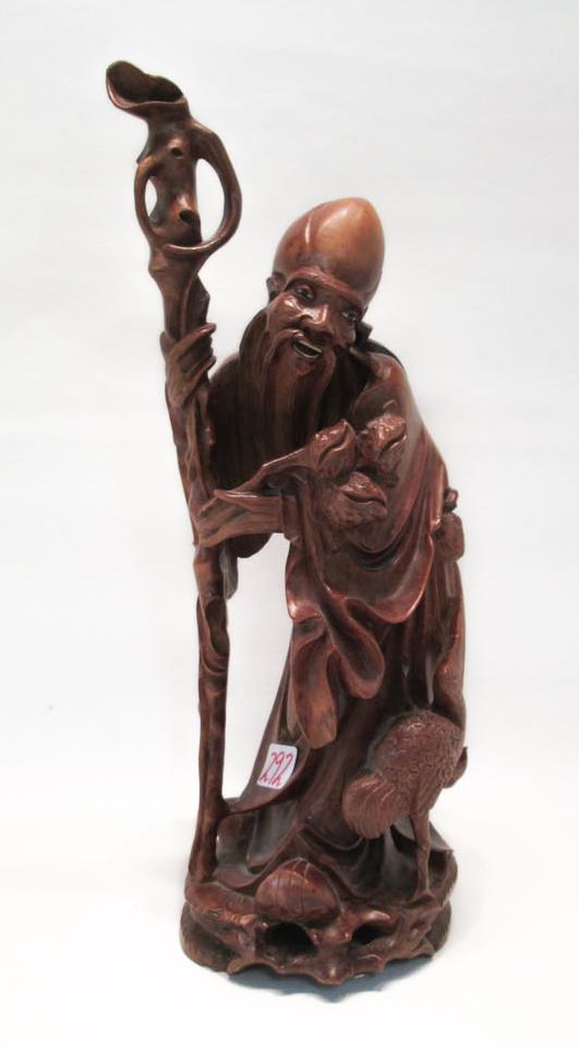 Appraisal: CHINESE CARVED HARDWOOD FIGURE of a male elder holding a