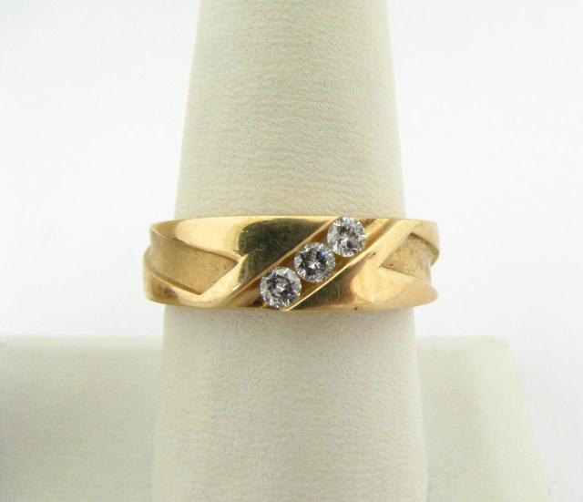 Appraisal: Gentleman's K yellow gold ring with three round channel set