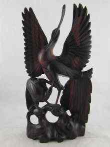 Appraisal: A Balinese rosewood carving of birds one with wings displayed