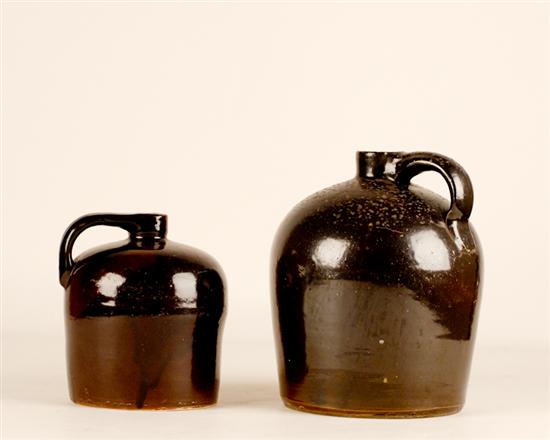 Appraisal: Two Stoneware Jugs both glazed brown and both with applied