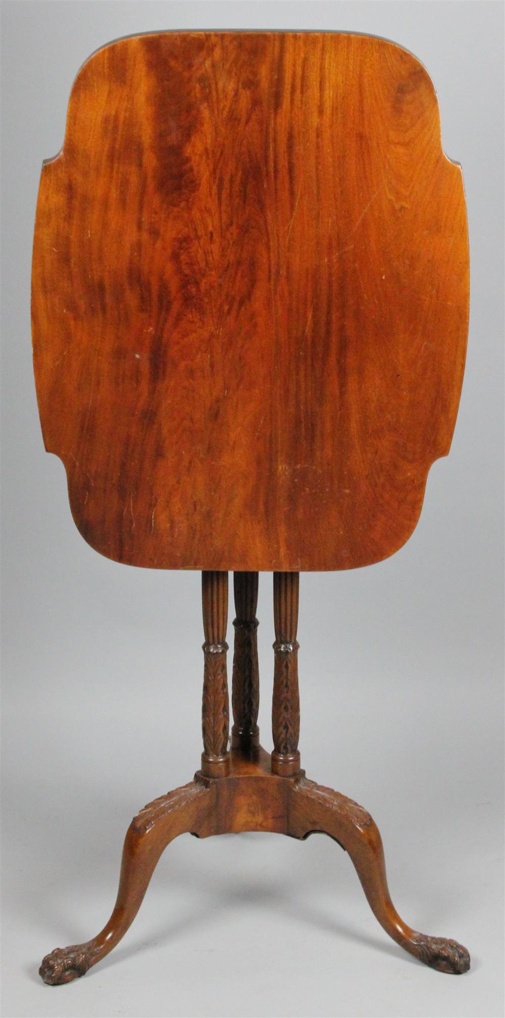 Appraisal: A CLASSICAL STYLE CARVED MAHOGANY TILT-TOP TABLE ON TRIFID PLINTH