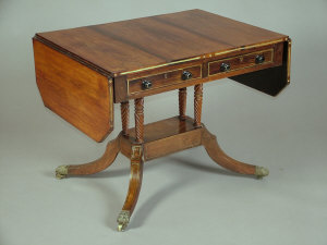 Appraisal: A Regency rosewood sofa table circa the canted top with