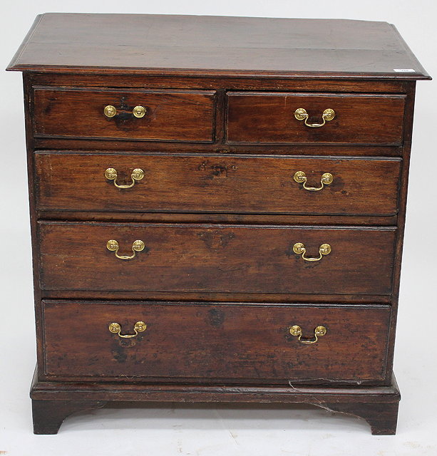 Appraisal: A GEORGE III SMALL OAK CHEST OF TWO SHORT AND