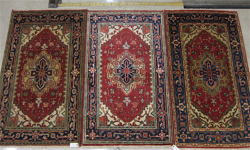 Appraisal: THREE SIMILAR ORIENTAL AREA RUGS Persian Serapi central medallion design