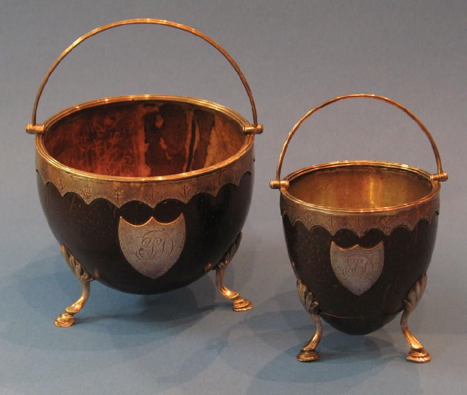 Appraisal: A GEORGE III SILVER MOUNTED COCONUT CUP with a swing