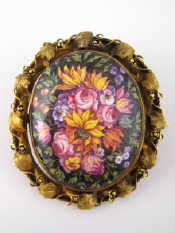 Appraisal: A carat gold reversible locket brooch with enamelled floral design