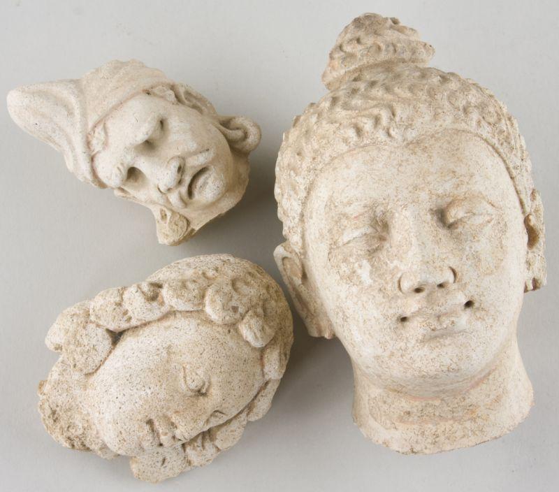 Appraisal: Three Gandharan-Style Stucco Heads the largest depicting Buddha in the