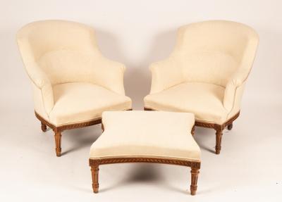 Appraisal: A pair of upholstered armchairs and matching stool on turned