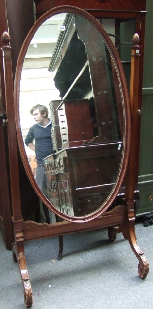 Appraisal: A mahogany framed cheval mirror the oval plate with bead