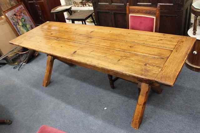 Appraisal: AN ANTIQUE PINE DINING TABLE the plank top with cleated