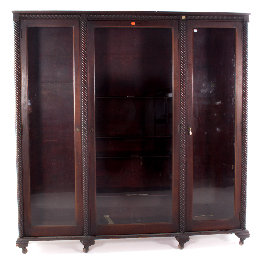 Appraisal: Classical Revival mahogany bookcase with three glass paneled doors spiral