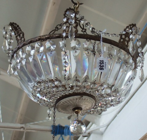 Appraisal: A two tier gilt brass bag chandelier hung with cut