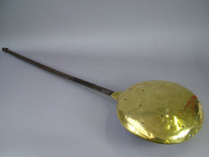 Appraisal: A Queen Anne brass warming pan with iron long handle