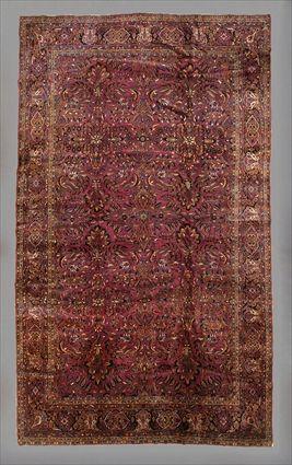 Appraisal: SAROUK CARPET The wine red field worked with floral stems