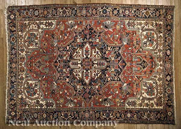 Appraisal: A Semi-Antique Heriz Carpet red and cream ground central medallion