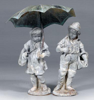 Appraisal: Two similar lead garden figures young girl holding patinated copper