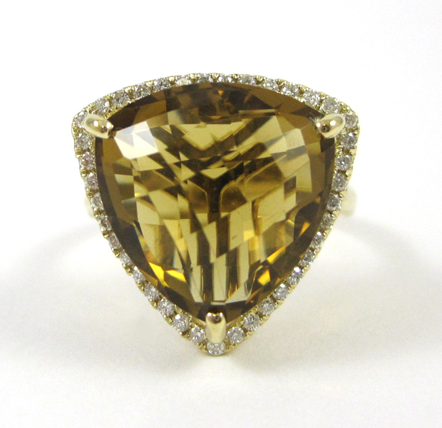 Appraisal: GOLDEN TOPAZ AND FOURTEEN KARAT GOLD RING with round-cut diamonds