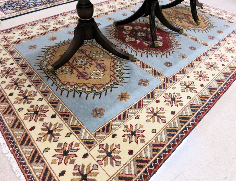 Appraisal: HAND KNOTTED ORIENTAL CARPET Indo-Kazak featuring three rectangular sky-blue reserves