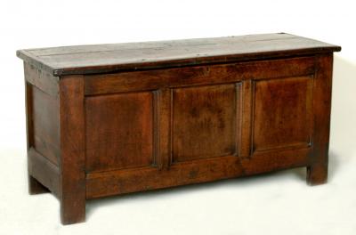 Appraisal: AN OAK COFFER with heavy plank top three moulded front