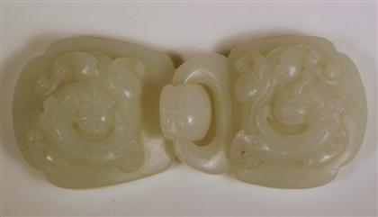 Appraisal: Chinese white jade buckle The rounded square-form buckles carved in