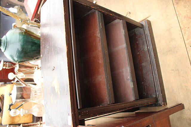 Appraisal: A SMALL STAINED PINE DWARF BOOKCASE on a plinth base