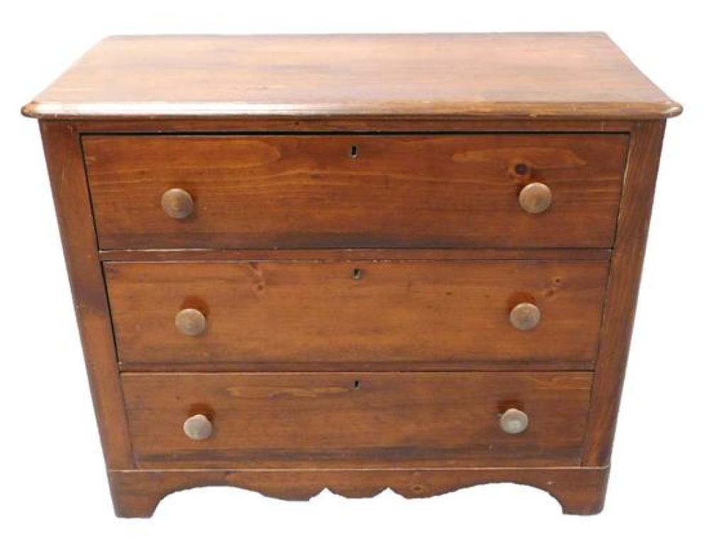 Appraisal: Pine three drawer chest wood knob pulls cyma curved skirt