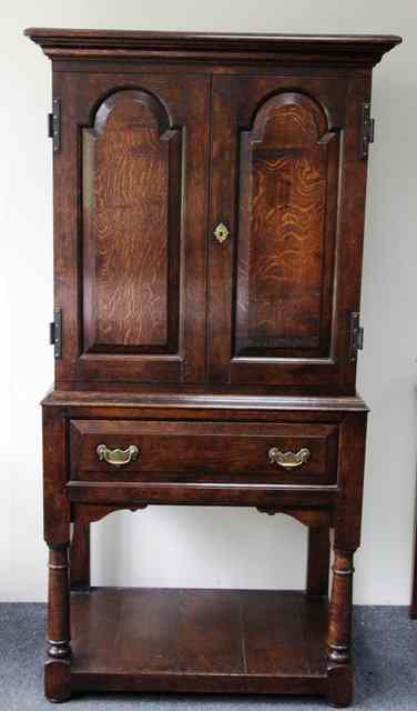 Appraisal: An th Century style oak cabinet on stand with moulded