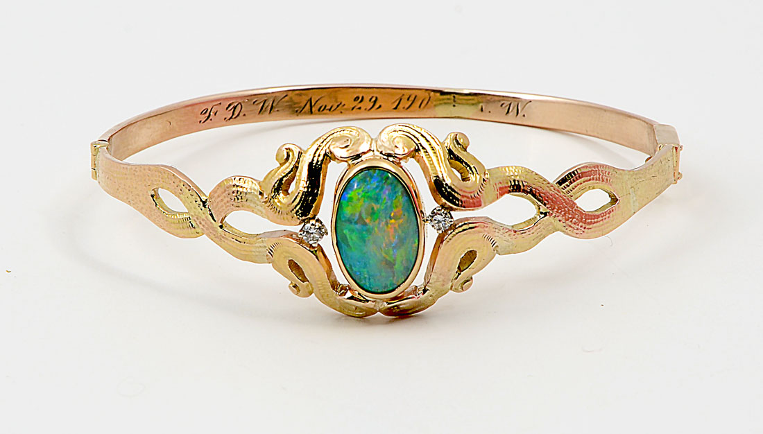 Appraisal: K OPAL BANGLE BRACELET K yellow gold bangle bracelet contains