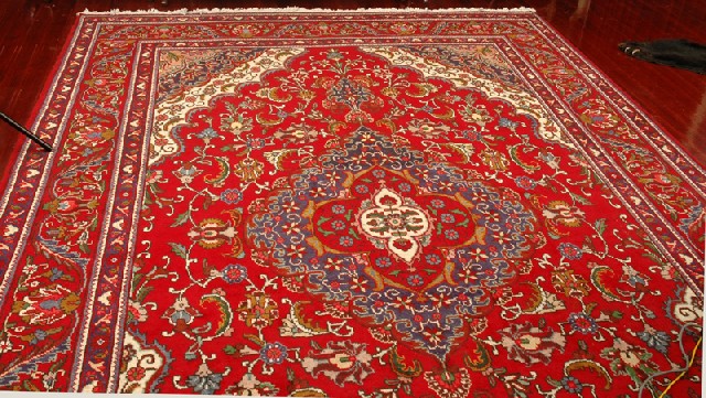 Appraisal: A RED GROUND PERSIAN FLOOR RUG x cm