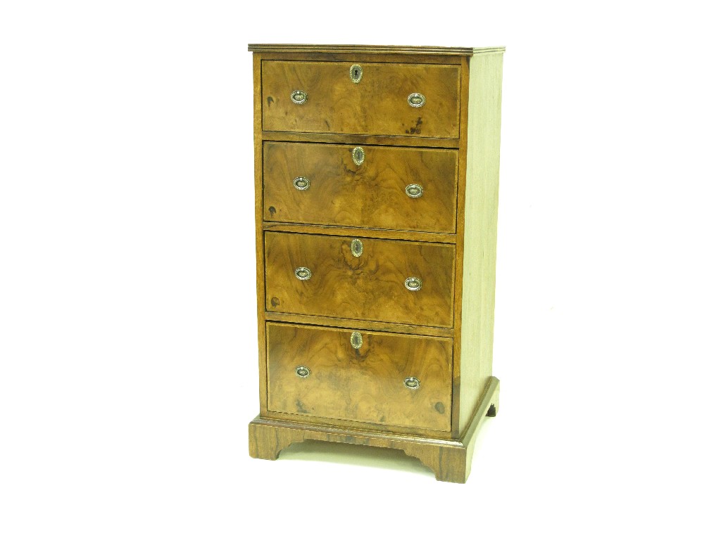 Appraisal: An antique walnut narrow Chest of four drawers with feather