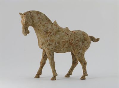 Appraisal: A Chinese pottery model of a horse walking and saddled