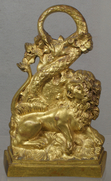 Appraisal: Cast brass lion and serpent doorstop iron weighted base h